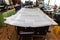 Gray ceiling lining removed from the car for tuning and bracing with grey soft material on a table in the workshop on the