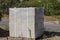 Gray cement blocks on a wooden pallet at the side of the road