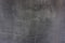 Gray cement plaster with sanding marks and scratches on the wall