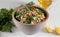 Gray ceramic bowl of Traditional Arabic salad Tabbouleh, side view, close-up