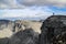 Gray, cold stone rocks in the majestic mountains of Russia. In the distance you can see the silhouette