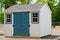 Gray color prefab gardening tools storage shed in the house backyard nature dress facade