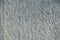 Gray concrete inhomogeneous background, porous rough uneven text