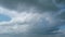 Gray cumulus rain dark clouds panoramic view. Massive dark rain storm clouds bg for weather forecast. Timelapse.