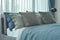 Gray and deep blue pillows setting on bed in deep blue color scheme