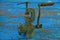 Gray dirty meat grinder on blue wooden table