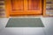 Gray door mat with close door
