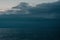 Gray dramatic sky with clouds over the sea in evening light