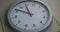 Gray dusty wall clock in a time lapse. Sun and shadow disturbance.