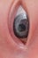 Gray eye of a newborn baby, close-up. Macro photo of a child open eye with an iris and a pupil