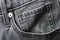 A gray fashion jeans denim front pocket details surface texture background close up