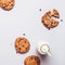 Gray food Background with chocolate chip cookies and bottle of milk