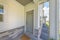 Gray front door of a townhome with glass panes and doormat