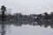 Gray frozen lake covered with a thin layer of mirror water