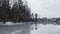 Gray frozen lake covered with a thin layer of mirror water