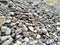 Gray gravel stones for the construction industry. Mound of granite gravel, stones, crushed stone close-up