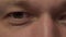 Gray-green eyes of a young man, close-up, camera movement
