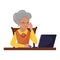 A gray-haired elderly woman is carefully reading something on the laptop screen. The concept of using a computer by elderly people