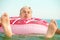 Gray-haired funny man swims on inflatable circle in the sea