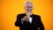 Gray-haired man in suit toasting with champagne glass, celebrating life, holiday