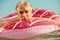 Gray-haired man swims on an inflatable circle in the sea