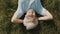 Gray haired woman pensioner lying on the grass with hands under her head. overhead close up shot