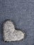 gray heart on blue fabric background