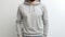 Gray hoodie mockup template front view of man, clipping path, isolated on white wall