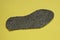 gray insole made of felt on a yellow table