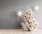 Gray interior with white Christmas tree and hanging glowing paper stars decoration