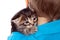 Gray kitten on boy\'s shoulder