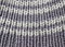 Gray knitted background. Knitted texture. A sample of knitting.