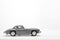 Gray little ancient model toy car isolated on background.