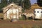 Gray mare in front of barn with horse trailer, WA