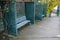 Gray metal benches hidden in the arcade. green lattice trellises in a row along the way. Park with romantic alcoves on theu terrac