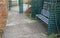 Gray metal benches hidden in the arcade. green lattice trellises in a row along the way. Park with romantic alcoves on theu terrac