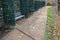 Gray metal benches hidden in the arcade. green lattice trellises in a row along the way. Park with romantic alcoves on theu terrac