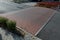 Gray metal bollards are used to protect pedestrians in the pedestrian