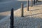 Gray metal bollards are used to protect pedestrians in the pedestrian zone or in the park on the promenade. gray pillars prevent p