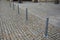 Gray metal bollards are used to protect pedestrians in the pedestrian zone or in the park on the promenade. gray pillars prevent p