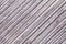 Gray multicolor background of a knitted textile material. Fabric with a striped texture closeup.