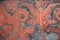 Gray and orange teracotta fresco ornament on ancient wall in Victorian style