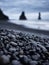 Gray pebbles as a background in the Iceland sea shore. Abstract composition.