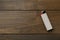 Gray plastic cigarette lighter on wooden table, top view. Space for text