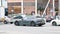 Gray Porsche Panamera Turbo Sport turismo moving on a busy street in center of Moscow. Rear left side view of premium car in