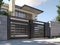 A gray private house of two floors hidden behind a fence with automatic sliding brown gates