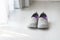 Gray, purple fabric shoes beside view
