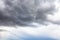 Gray rainy clouds in blue sky on summer day