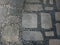 Gray rectangular stone and pebbles scattered on the ground