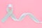 Gray ribbon on pink isolated background copy space. Brain Cancer Awareness, Brain Tumors, Allergies, Asthma, Diabetes Awareness,